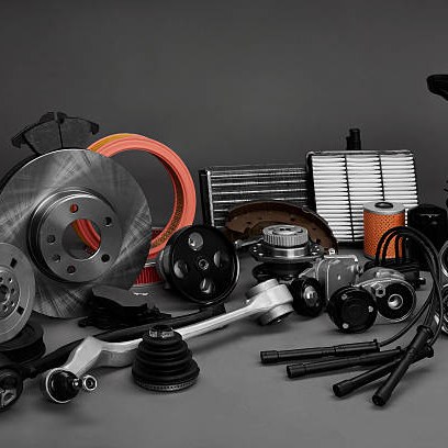 Genuine vehicle spares — brake disc, filters and belts — on the counter.